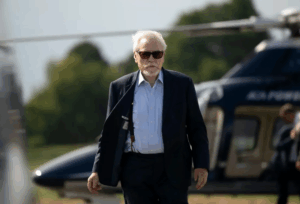 A still from the show Succession featuring protagonist Logan Roy walking in front of a helicopter