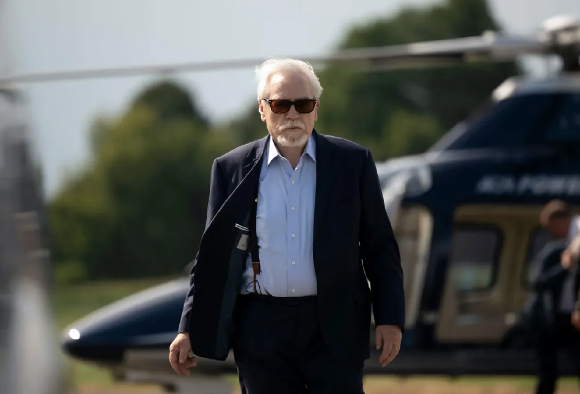 A still from the show Succession featuring protagonist Logan Roy walking in front of a helicopter